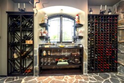 46 - An arched window is a perfect complement to the old-age design inspiration of this home wine room. photo of traditional home wine cellar with incredible stoneworks