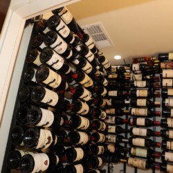 (3) Floor-to-ceiling metal racks make this small wine closet design highly functional.